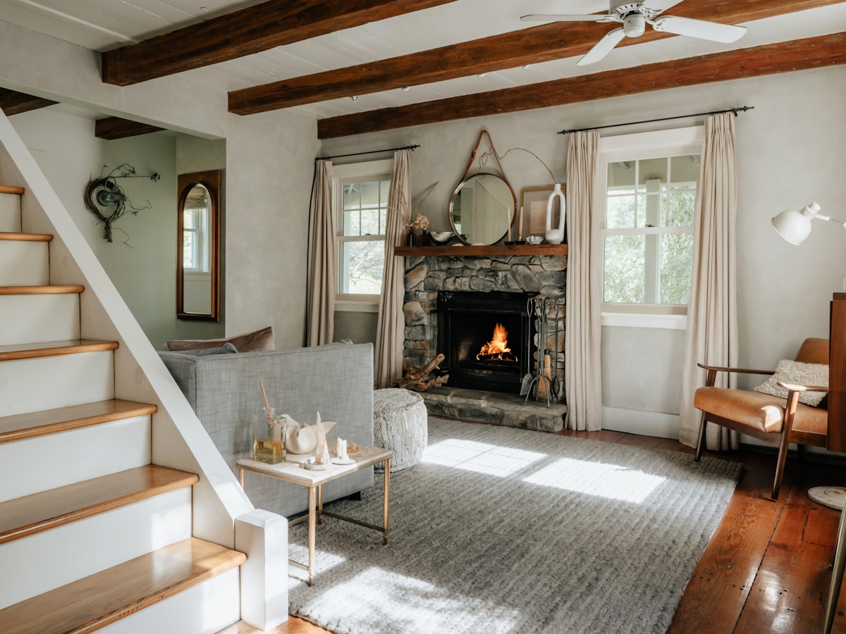 A warm holiday-let living room with a lit fireplace